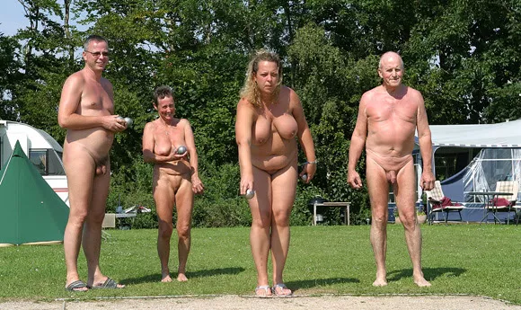 Tan and pudgy nudist playing bocce