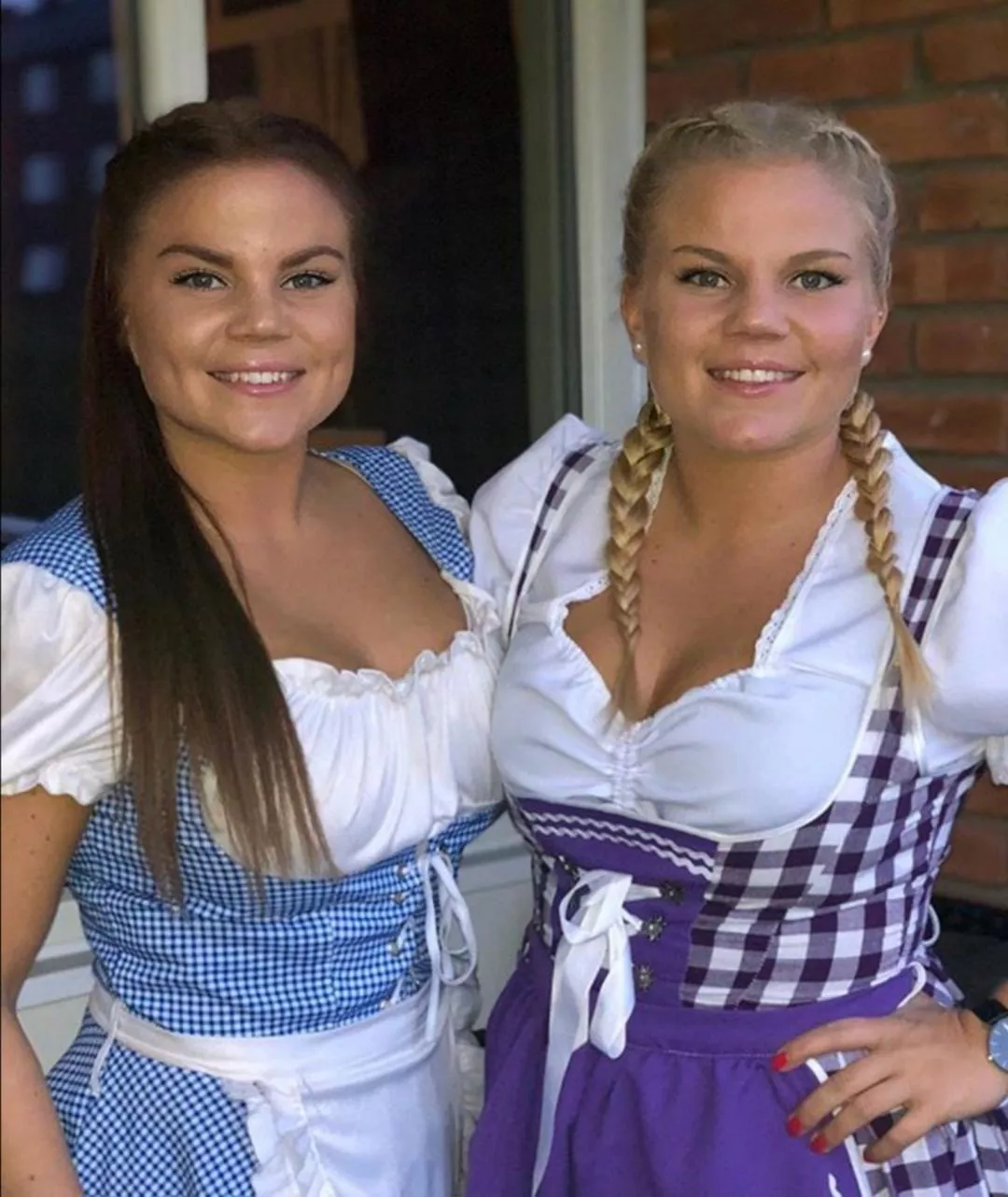 Two cute sisters in dirndl