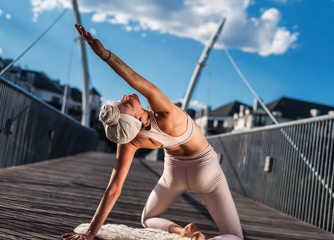 Yoga girl under the blue skies and sunshine